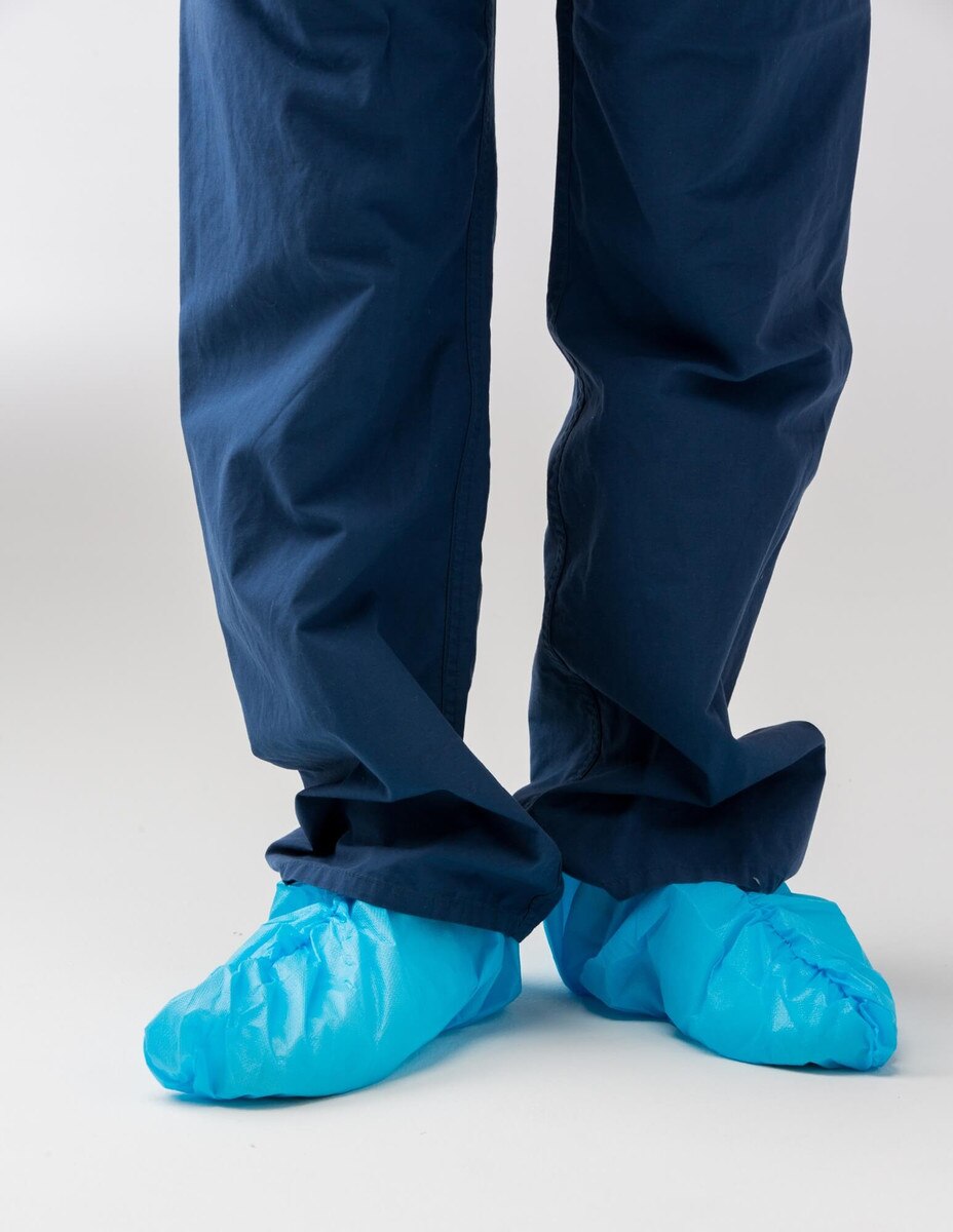 Front view of blue 16-inch non-sterile disposable shoe covers worn over shoes